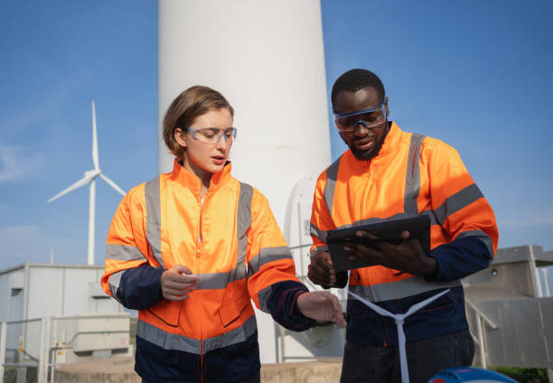 istock Team of engineer meeting about wind turbine project. 1502954559