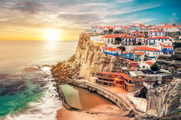 Azinheiras do Mar landscape, fishing village with colorful houses of fishermen at sunset in Azenhas do Mar, Colares, Sintra, Portugal.
