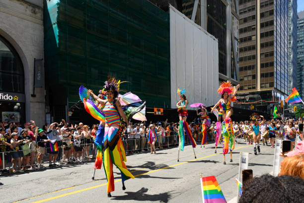 personas sobre zancos celebran en el desfile pride toronto 2023 el 25 de junio - royal bank of canada fotografías e imágenes de stock