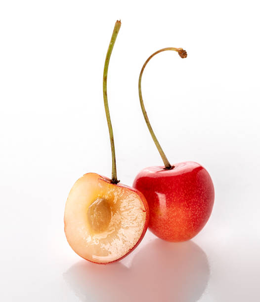 istock cherry  cut in half with a stone isolated on a white background 1502959840