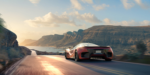 A generic red electric sports car viewed from behind, driving at speed along a hilly mountainous coastal path at sunrise or sunset, under a blur sky with white clouds.  With motion blur to the foreground and wheels.