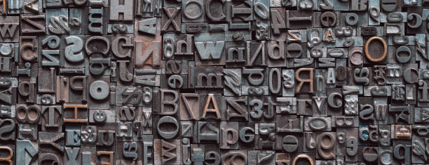 letterpress background, close up of many old, random metal letters with copy space - letterpress typescript alphabet wood imagens e fotografias de stock