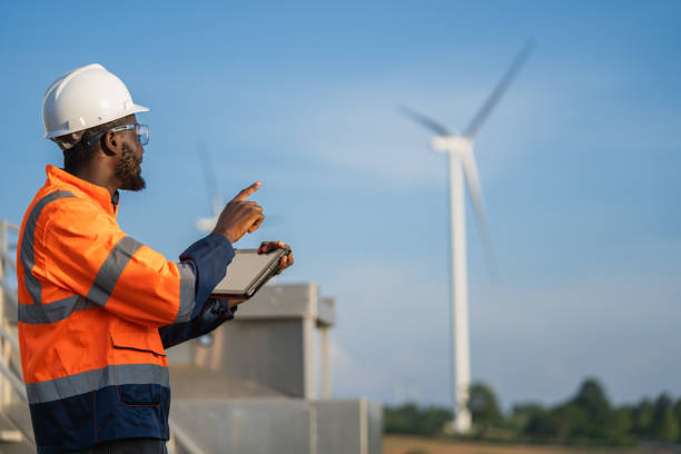 istock Engineer man using tablet for windturbine sustainable energy generator project. 1502965135