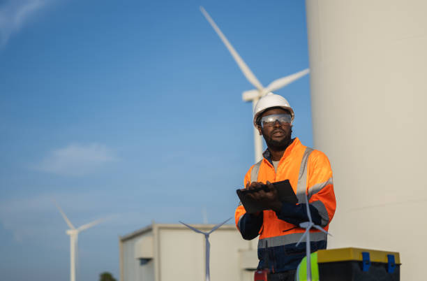 istock Engineer man using tablet for windturbine sustainable energy generator project. 1502965136