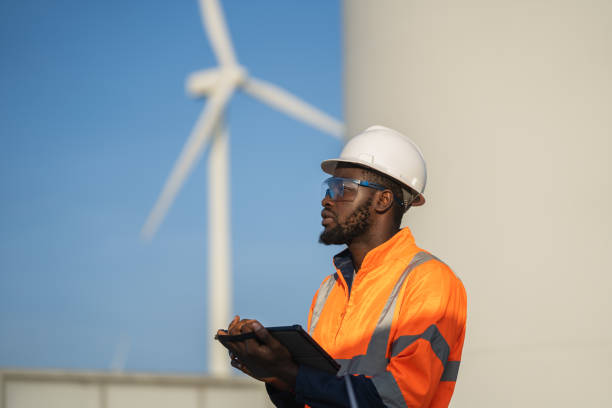 istock Engineer man using tablet for windturbine sustainable energy generator project. 1502965145