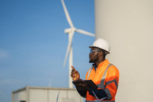istock Engineer man using tablet for windturbine sustainable energy generator project. 1502965148