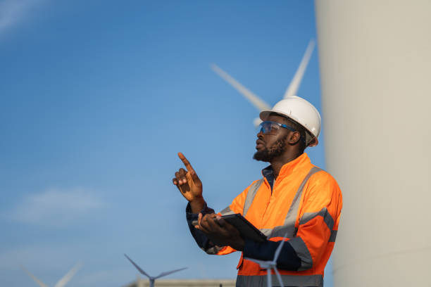 istock Engineer man using tablet for windturbine sustainable energy generator project. 1502965153
