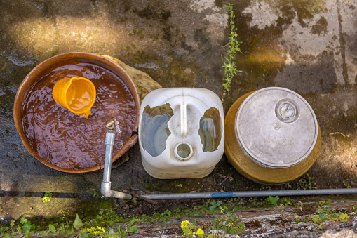 Clean pots waiting for streamline flow of water from tap