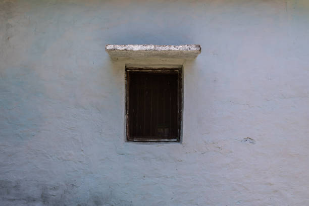 closed wooden window in a stone wall, copy space. vintage and traditional wood window used in Indian state of Uttarakhand.