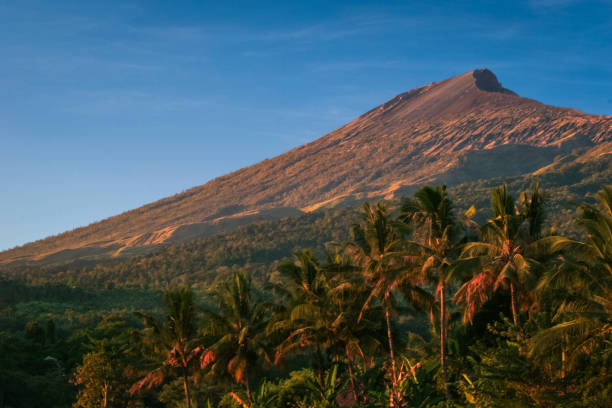 The towering peak of Mount Rinjani, an active volcano which rises to 3,726 metres and the second highest volcano in Indonesia viewed from the village of Senaru in North Lombok, West Nusa Tenggara, Indonesia.