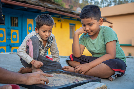 Indian village school kids playing carrom board