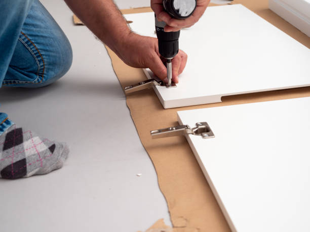 istock A man assembles furniture at home with a professional screwdriver. 1502967819