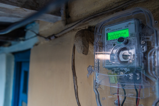 Modern Indian electric meter in rural. energy meter is a device that measures the amount of electric energy consumed by a residence, a business, or an electrically powered device