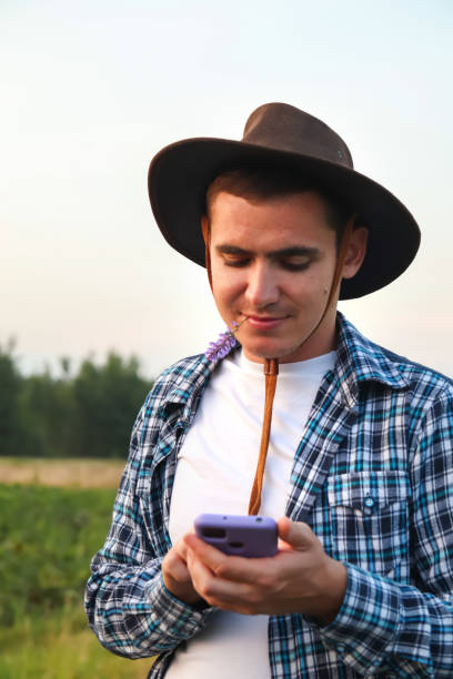 istock Farmer using phone. a young farmer diligently tends to the irrigation system, inspecting and fine-tuning the center pivot sprinklers 1502968854