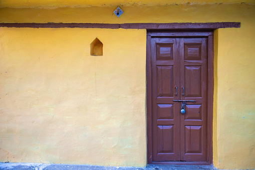 old wooden Door with yellow wall