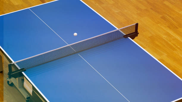 Professional table tennis table and professional table tennis racket, background picture, blank for design, selective focusing, tinted image.
