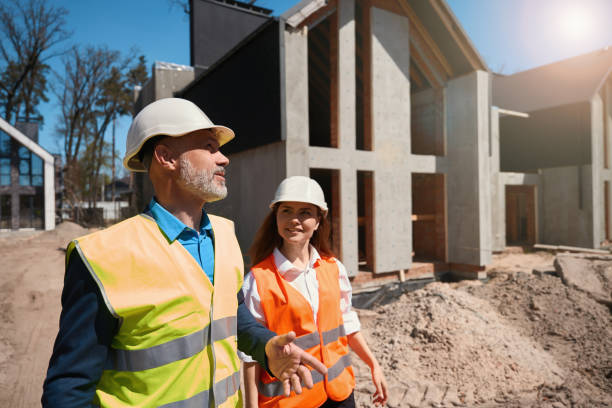 istock House developers in hardhats and safety vests walking at construction site 1502974154