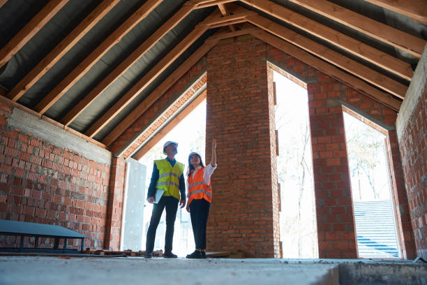 Loft contractors inspecting construction progress in an open-frame structure