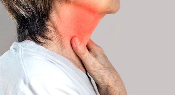 Redness at the neck of Asian, Myanmar woman. Concept of sore throat, pharyngitis, laryngitis, esophagitis, thyroiditis, or dysphagia.