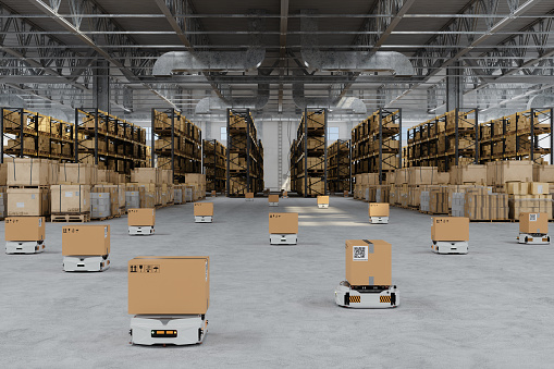 Distribution Warehouse With Automated Guided Vehicles Carrying Cardboard Boxes
