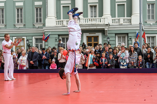 Moscow, Russia - September, 2017: Demonstration performances of capoeira masters. Celebration in honor of the day of the city. City center. Crowd of spectators.