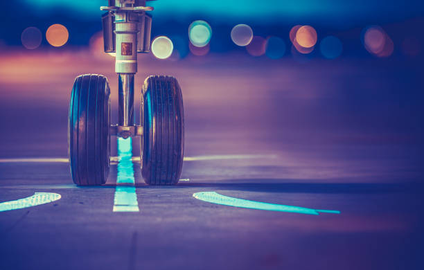 Airplane Wheels On The Runway At Sunset stock photo