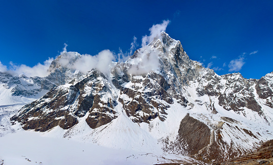 370 MPix XXXXL size panorama of Mount Ama Dablam - probably the most beautiful peak in Himalayas.  This panoramic landscape is an very high resolution multi-frame composite and is suitable for large scale printing. Ama Dablam is a mountain in the Himalaya range of eastern Nepal. The main peak is 6,812  metres, the lower western peak is 5,563 metres. Ama Dablam means  'Mother's neclace'