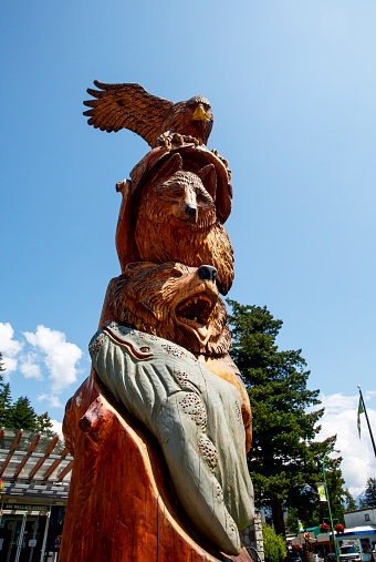 Totem pole depicting an eagle, wolf, bear and whale