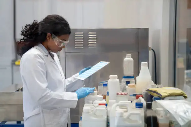 Photo of Chemist doing research while working at an industrial lab