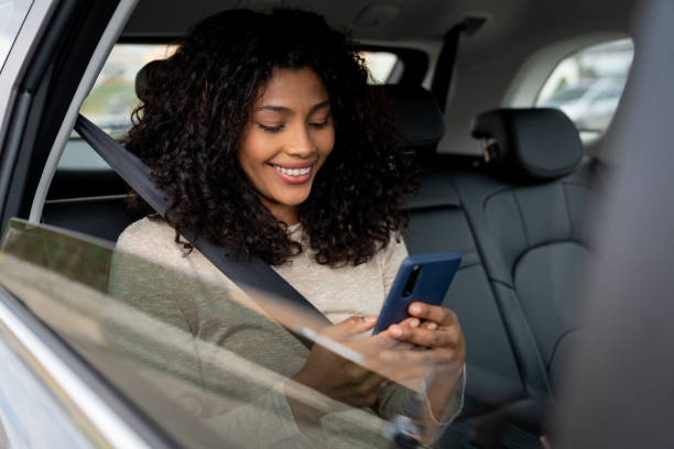 istock Woman texting on her cell phone while riding on a crowdsourced taxi 1502994732
