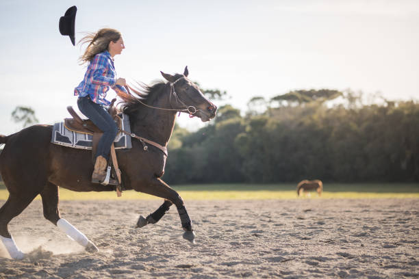 istock Woman's cowboy hat falling while she is horseback riding 1503003697