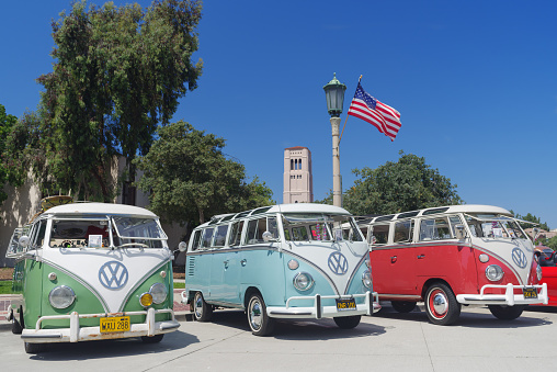 Pasadena, California, United States: three vintage Volkswagen Buses, green, sky blue and red, collector's car, shown parked in the civic center of the City of Pasadena.