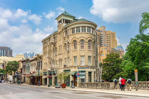 San Antonio, Texas, USA – May 8, 2023: Vintage buildings and bridge on Commerce Street in downtown San Antonio, Texas.