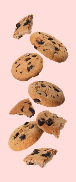 istock Delicious chocolate chip cookies falling on pink background 1503012650