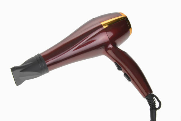 Red hair dryer with nozzle. 
isolated on white background. stock photo