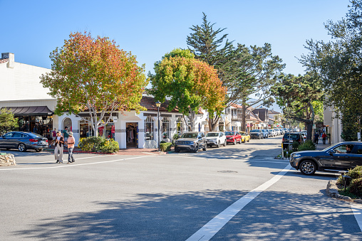 Carmel-By-The-Sea, CA - October 18, 2022: View of Ocean avenue on a clear afternoon. Ocean Avenue, downtown Carmel's main street, is lined with many shops, coffee houses, and galleries.