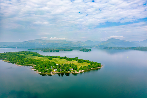 Aerial view of Loch Lomond and green island in the highlands of Scotland.