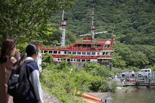 May 27, 2023 - Lake Ashi, Japan: Visitors view a tour boat undergoing maintenance at Togendai Port. Spring morning on the waterfront of Lake Ashinoko, the crater lake.