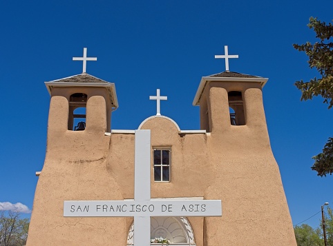 The San Francisco de Assisi (Saint Francis of Assisi) Catholic Mission Church in Ranchos De Taos, New Mexico is a Spanish colonial church completed in 1816.  This image was taken the Monday after Easter, so the cross is still draped in white. 