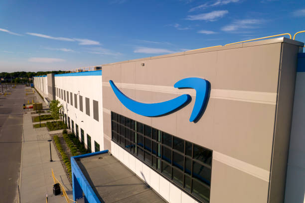 Amazon logo on the new build modern building. Amazon Smile Arrow logo and brand trademark. Fulfillment center warehouse and office building. stock photo