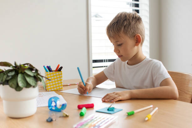 istock Cute boy doing school homework at home. Distance education. Online education. 1503035578
