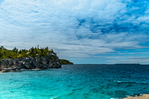 Bruce Peninsula National Park, Canada – June 27, 2022 Indian Head Cove at Tobermory, turquoise blue water and green pine forest in Ontario. Summer day at Bruce Peninsula National Park near Bruce trail