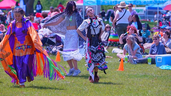 Pow Wow, 2nd Annual Two Spirit Powwow, by 2-Spirited People of the 1st Nations. Women traditional dance in Jingle Dress a healing or medicine dress: Toronto, Ontario, Canada - May 27, 2023.