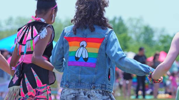 Annual Two Spirit Pow wow, by 2-Spirited People of the 1st Nations. Circle of friendship or friendship dance. A person with Two spirit pride flag on the shirt. stock photo