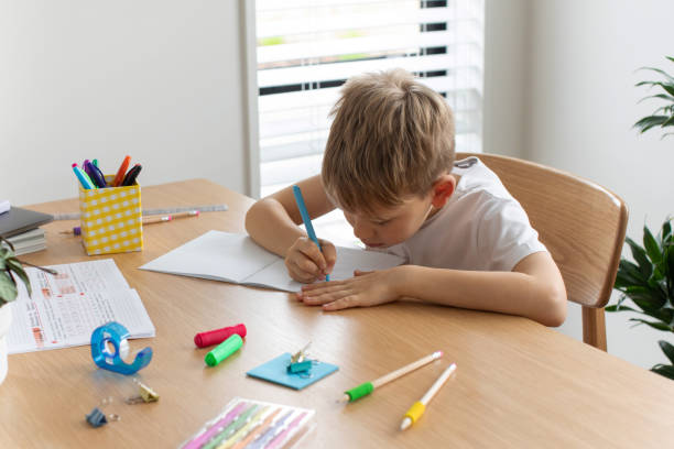 istock Cute boy doing school homework at home. Distance education. Online education. 1503035943