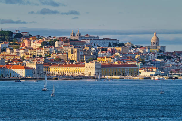 View of Lisbon view over Tagus river with yachts and boats on sunset. Lisbon, Portugal View of Lisbon over Tagus river from Almada with yachts tourist boats on sunset. Lisbon, Portugal national pantheon lisbon stock pictures, royalty-free photos & images