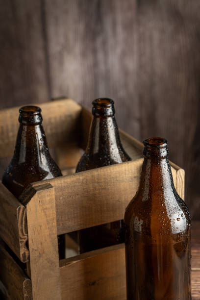 istock Empty amber beer bottles on rustic wooden background. 1503041850