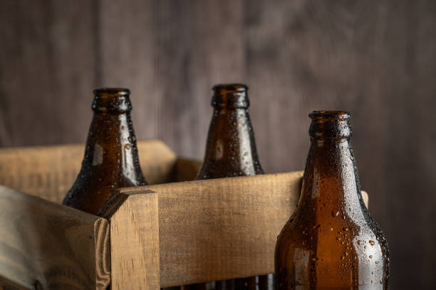 istock Empty amber beer bottles on rustic wooden background. 1503041859