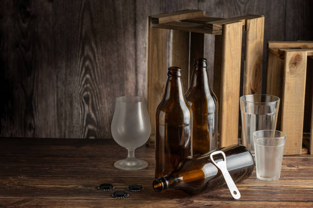 istock Empty amber beer bottles on rustic wooden background. 1503042399