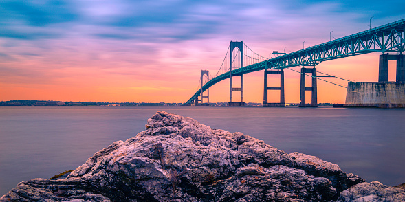 Dramatic beautiful sunset landscape over Claiborne Pell Newport Bridge, a modern tolled suspension bridge across Narragansett Bay, connecting Newport  Jamestown, Rhode Island